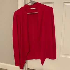 Pink open-front blouse.